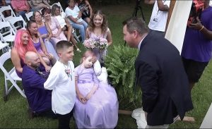 Brave little girl wheeled down the aisle by dad to marry school sweetheart days before passing away