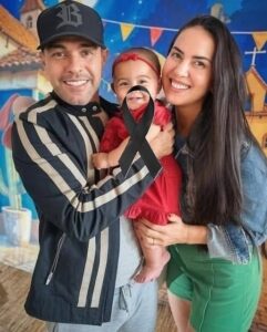 Young couple put daughter inside the fir…See more