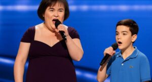 “Dad… I’m singing with her?!” Susan Boyle Brings Simon Cowell to Tears in Magical Duet With His Son! In a jaw-dropping twist no one expected, Susan Boyle stepped onto the Britain’s Got Talent stage alongside Eric Cowell, Simon Cowell’s young son, delivering a duet that left the audience breathless. Their voices intertwined perfectly, blending Susan’s soulful power with Eric’s tender innocence to create a harmony that felt lifted straight from a storybook. Cameras captured Simon’s reaction—eyes glistening, emotions raw—as he watched his son share the stage with a musical legend. What began as a regular episode transformed into a historic television moment, a once-in-a-lifetime memory of music, legacy, and pure heart. Fans flooded social media, calling it a performance that will be remembered forever.