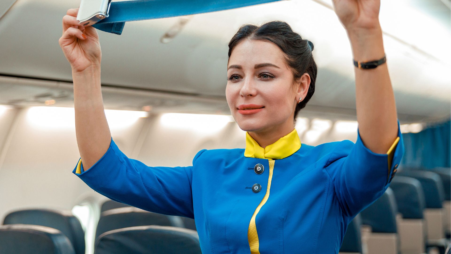 Flight attendant explains the unexpected reason cabin crew keep their hands under their thighs during takeoff and landing