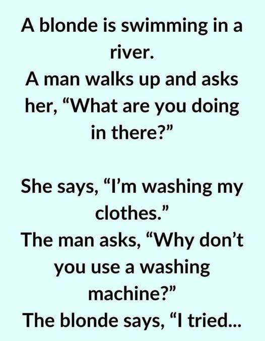 A blonde is swimming in a river.